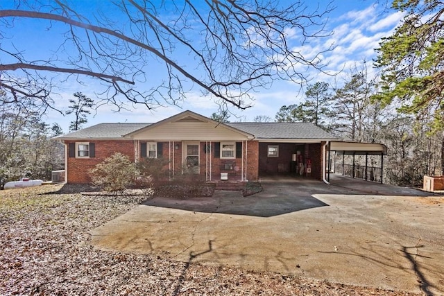 ranch-style house with a porch and a carport