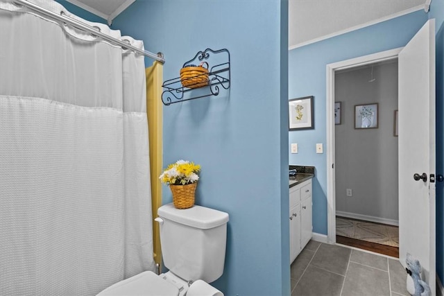 bathroom featuring tile patterned floors, vanity, crown molding, and toilet