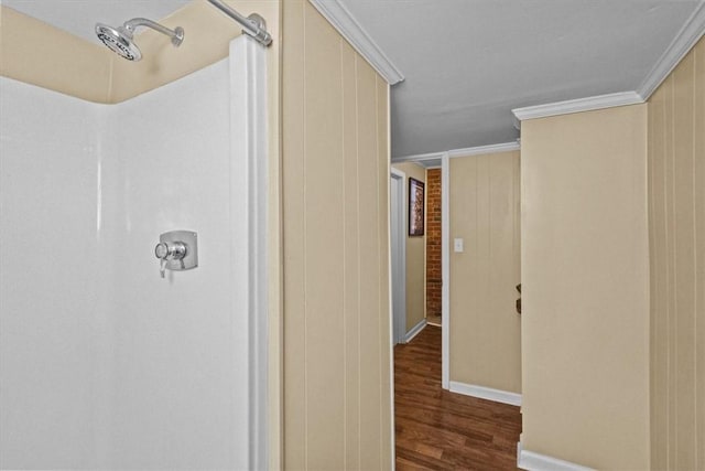 hallway with dark wood-type flooring and crown molding