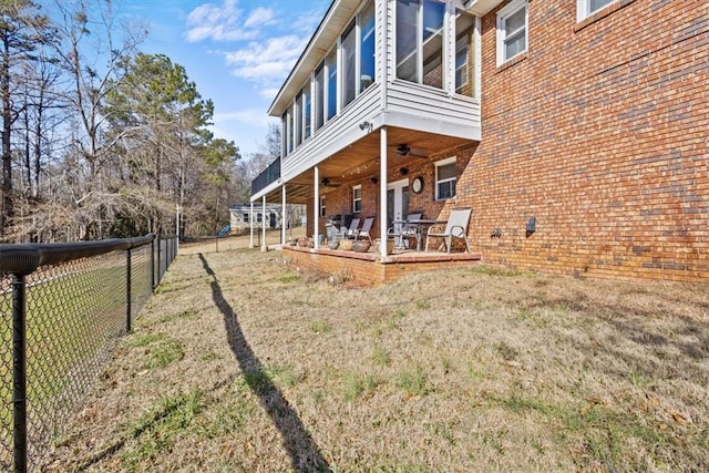 view of yard featuring ceiling fan and a patio