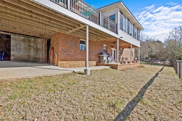 exterior space featuring a patio area, a lawn, and ceiling fan