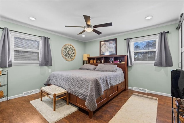 bedroom featuring ceiling fan, ornamental molding, and dark hardwood / wood-style flooring