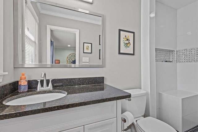 bathroom with toilet, vanity, crown molding, and walk in shower