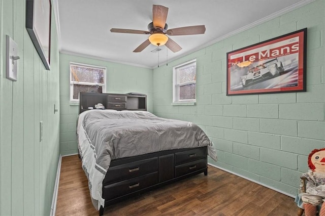 bedroom featuring ceiling fan, ornamental molding, and multiple windows