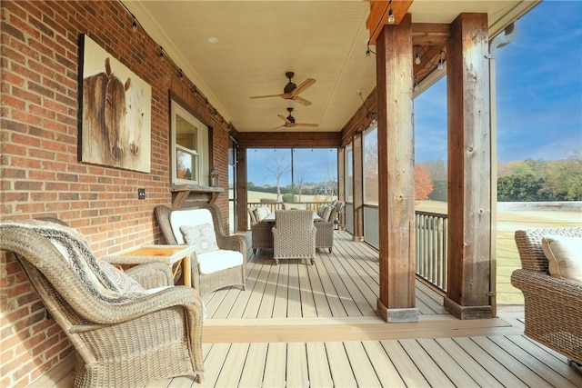 sunroom featuring ceiling fan