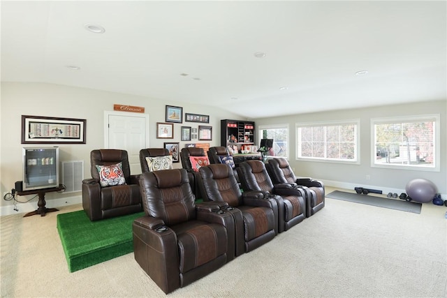 carpeted home theater room featuring golf simulator and lofted ceiling