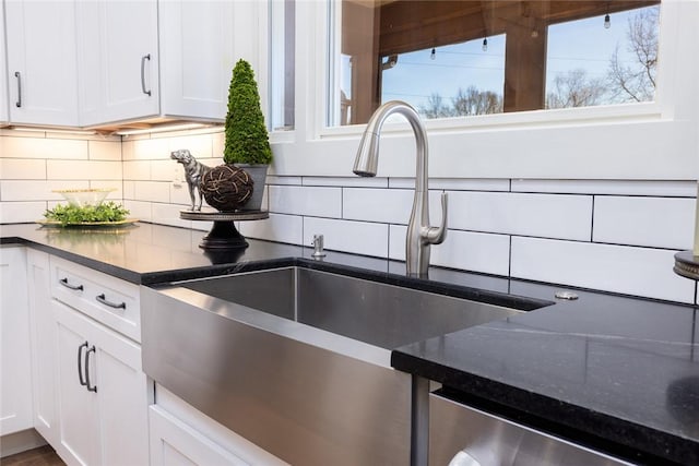 kitchen featuring white cabinets, backsplash, dishwasher, and sink