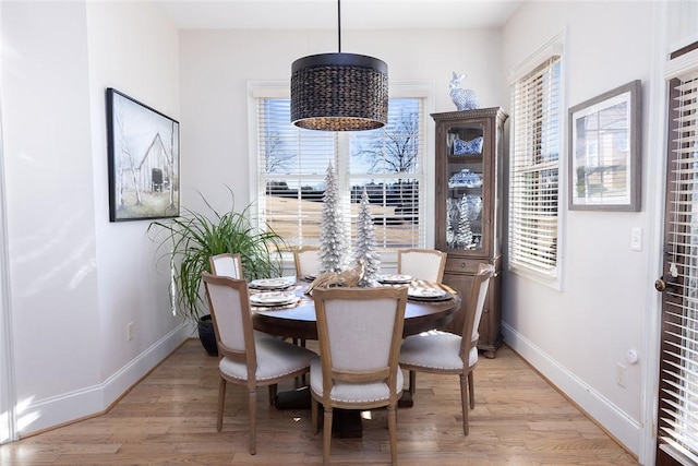 dining space with light wood-type flooring