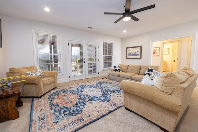 living room with french doors, carpet floors, and ceiling fan