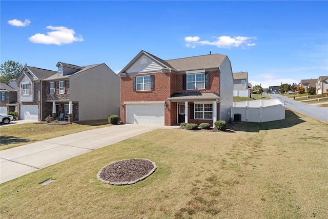 traditional-style house with brick siding, an attached garage, a gate, fence, and driveway