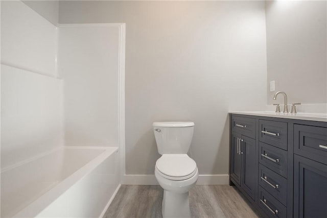 bathroom featuring hardwood / wood-style floors, vanity, and toilet