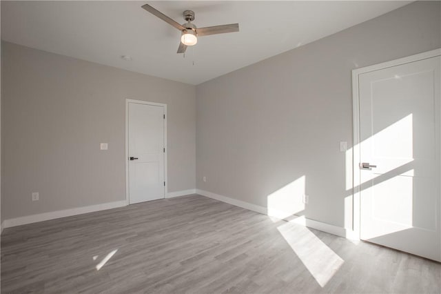 unfurnished room featuring light wood-type flooring and ceiling fan