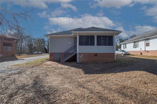 rear view of property with a sunroom