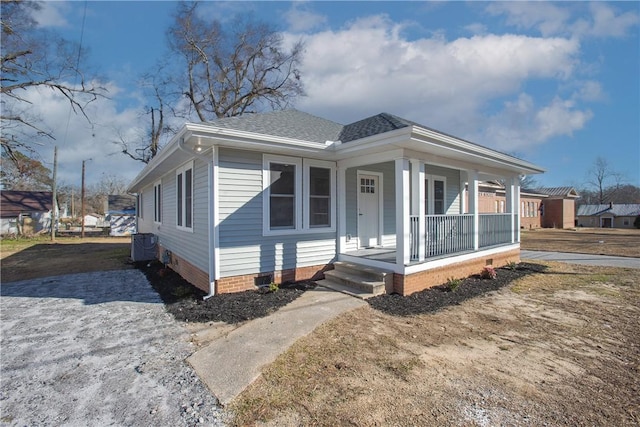 view of front of home with a porch and central air condition unit