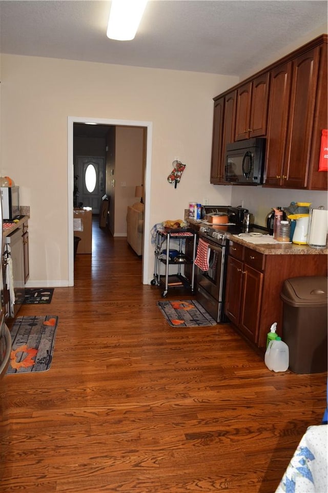 kitchen featuring dark hardwood / wood-style floors and stainless steel electric stove