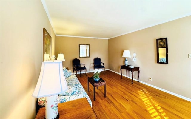 sitting room featuring hardwood / wood-style floors and ornamental molding