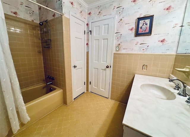 bathroom with shower / bath combo, vanity, and tile walls