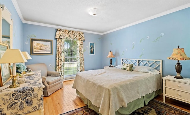 bedroom with a textured ceiling, light wood-type flooring, and crown molding