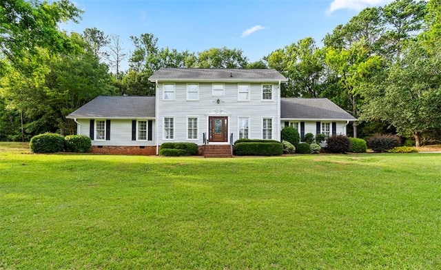 colonial inspired home featuring a front lawn