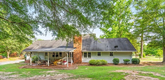 back of house with a lawn