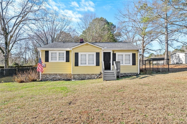 view of front of house with a front yard and a carport