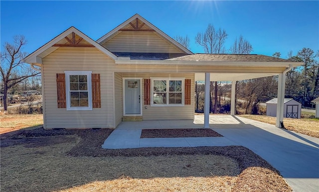 view of front of home featuring a storage unit