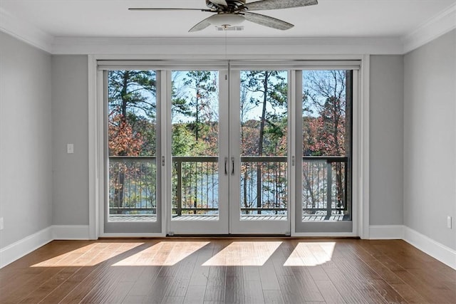 doorway featuring ceiling fan, plenty of natural light, crown molding, and french doors