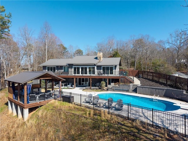 rear view of house with a patio area, a wooden deck, a gazebo, and fence