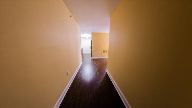 hallway with dark hardwood / wood-style flooring