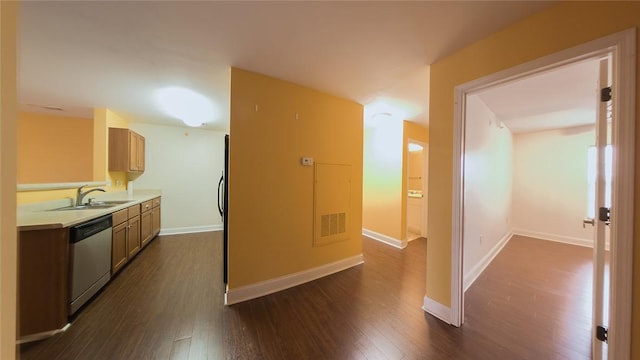 kitchen featuring dark hardwood / wood-style flooring, dishwasher, light brown cabinets, and sink