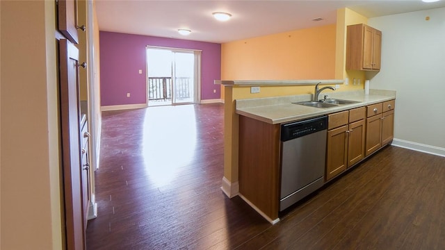 kitchen with dishwasher, kitchen peninsula, dark wood-type flooring, and sink