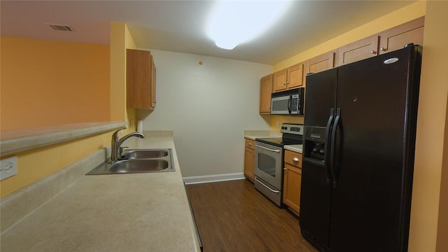 kitchen with stainless steel appliances, dark wood-type flooring, and sink