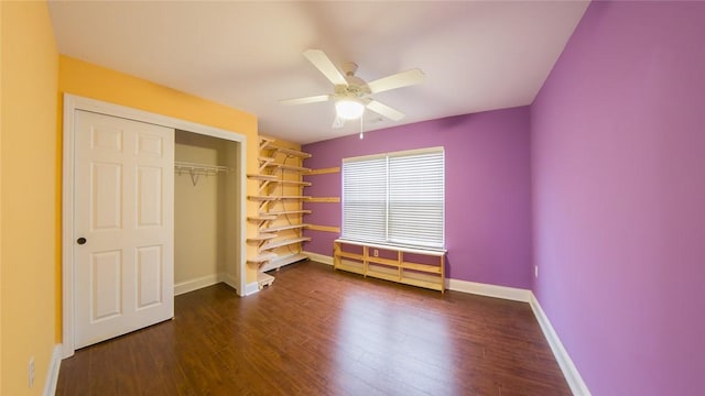 unfurnished bedroom featuring dark hardwood / wood-style flooring, ceiling fan, and a closet