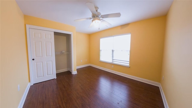 unfurnished bedroom featuring ceiling fan, dark hardwood / wood-style flooring, and a closet