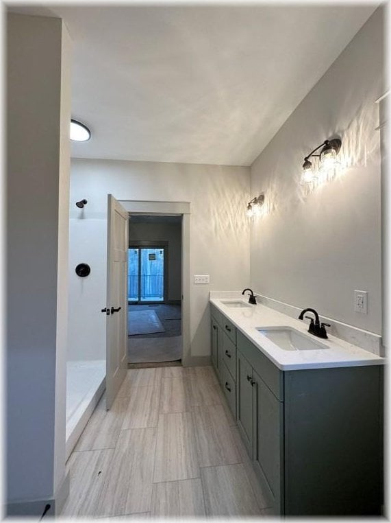 bathroom with a shower and vanity