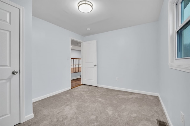 unfurnished bedroom featuring light colored carpet