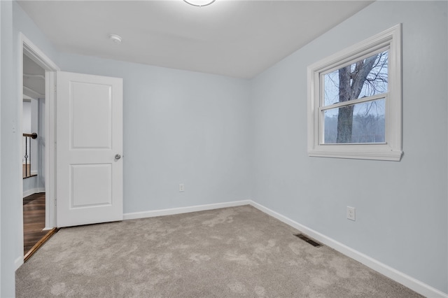 spare room with light carpet