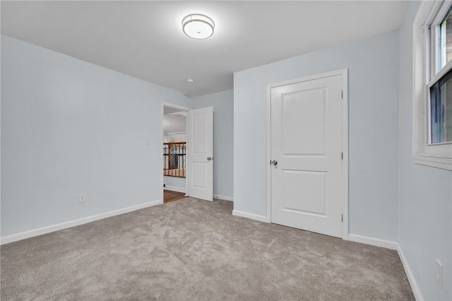 unfurnished bedroom featuring light carpet