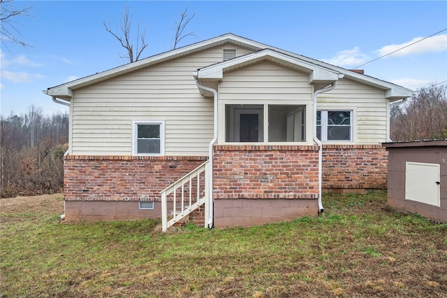 back of house with a lawn