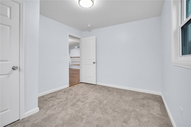 unfurnished bedroom featuring light carpet