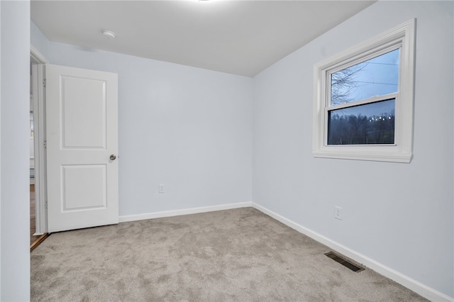 spare room with light colored carpet