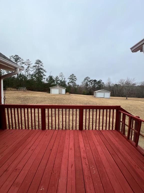 wooden deck with an outbuilding and a garage