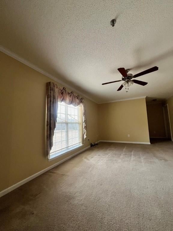 empty room featuring carpet flooring, ceiling fan, a textured ceiling, and ornamental molding