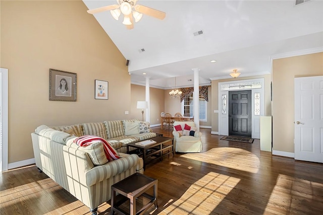 living room featuring decorative columns, ceiling fan with notable chandelier, dark hardwood / wood-style floors, and high vaulted ceiling