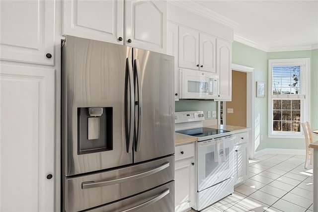 kitchen featuring light tile patterned floors, white appliances, white cabinetry, and ornamental molding