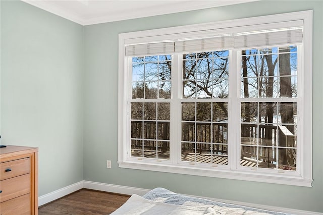 bedroom with dark hardwood / wood-style flooring and crown molding