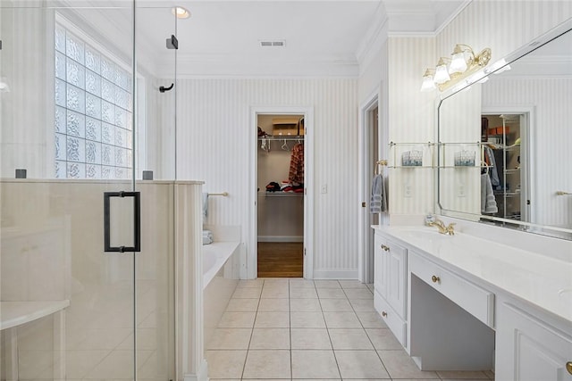 bathroom featuring tile patterned flooring, shower with separate bathtub, vanity, and ornamental molding