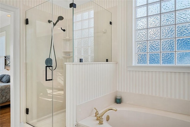 bathroom featuring shower with separate bathtub