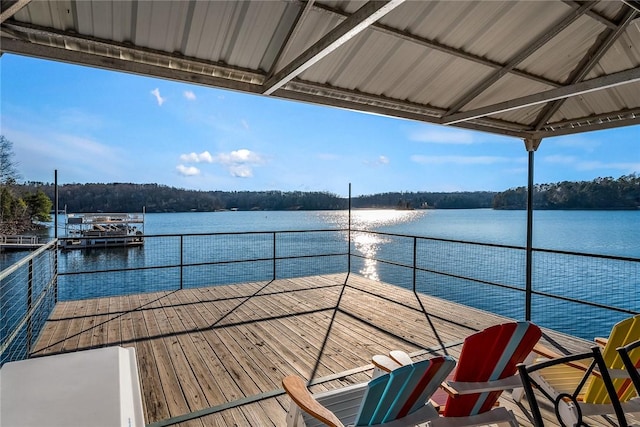 dock area with a balcony and a water view