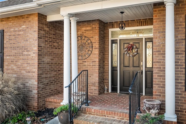 view of exterior entry with a porch